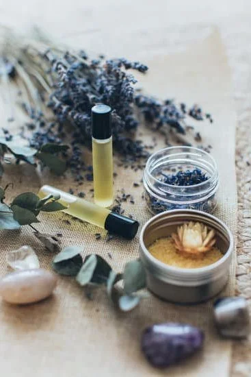 Image of a woman attending an Introduction to Aromatherapy Course, surrounded by various essential oils and herbs