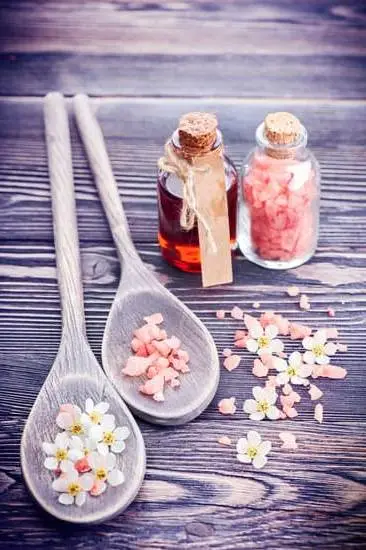 Does Aromatherapy Work for Anxiety 1 Image depicting a woman surrounded by aromatic essential oils, showing effectiveness of aromatherapy for anxiety relief